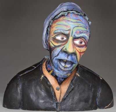 front view of ceramics sculpture of weather beaten homeless lady